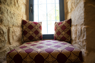 Stone nook with pillows in ktichen of Villa Tiferet, Tsfat. 